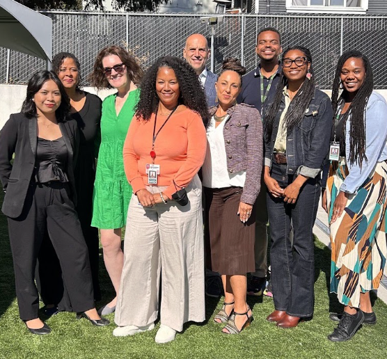 Nine nonprofit and fundraising partners gathered outdoors