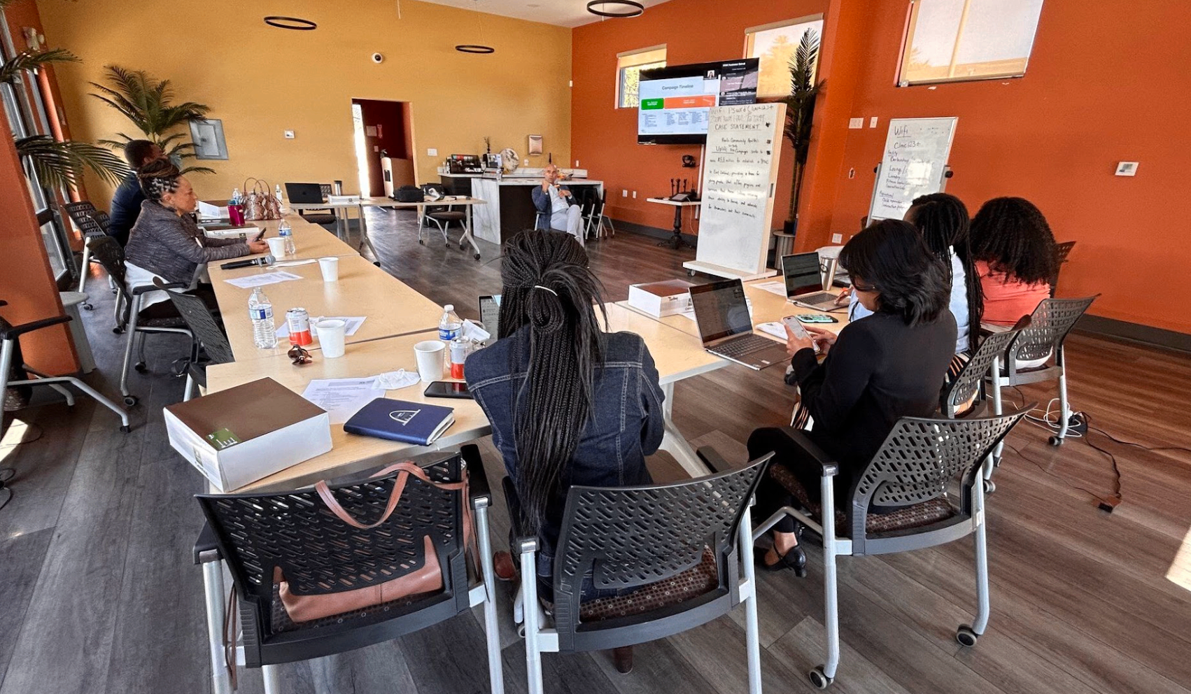 Participants working together around tables during a strategic planning workshop