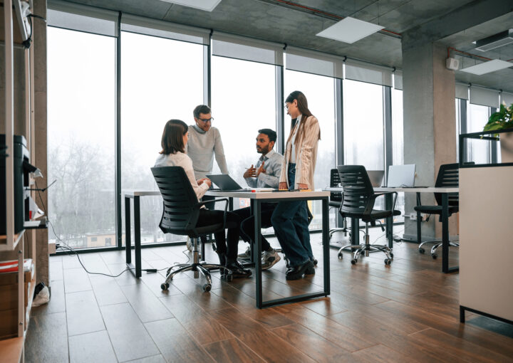 Four people working in an office together