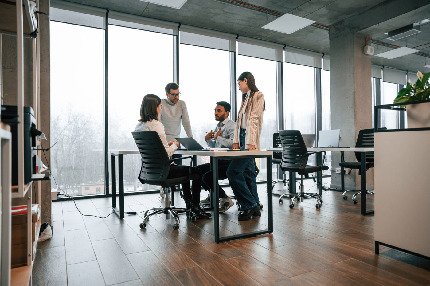 Four people working in an office together